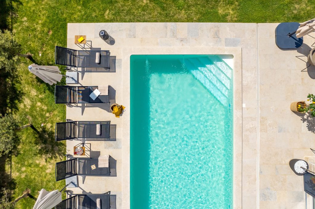 Aerial close-up of the sun loungers by the pool