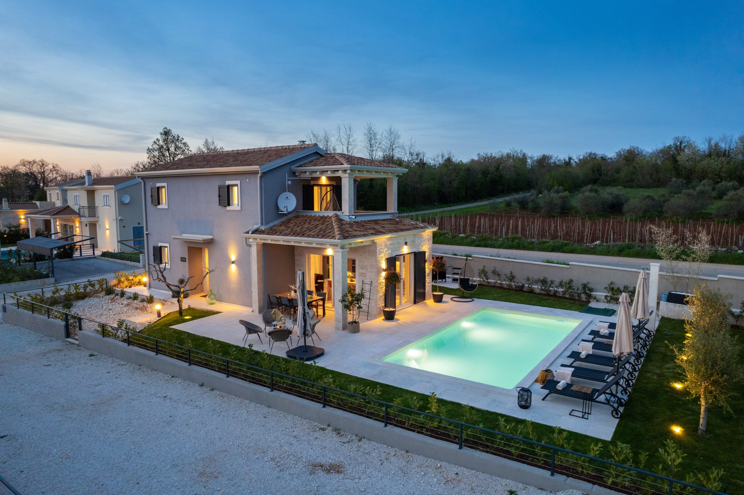 Aerial dusk view of the pool and dining terrace