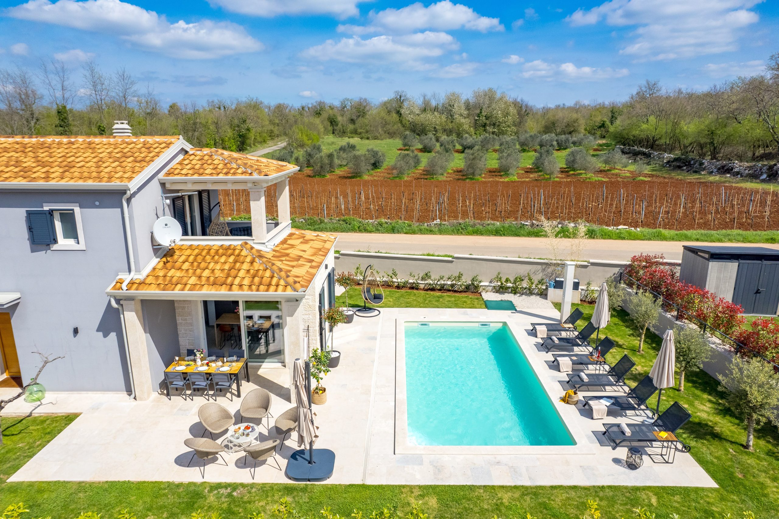 Aerial view of the villa surrounded by vineyards and olive groves