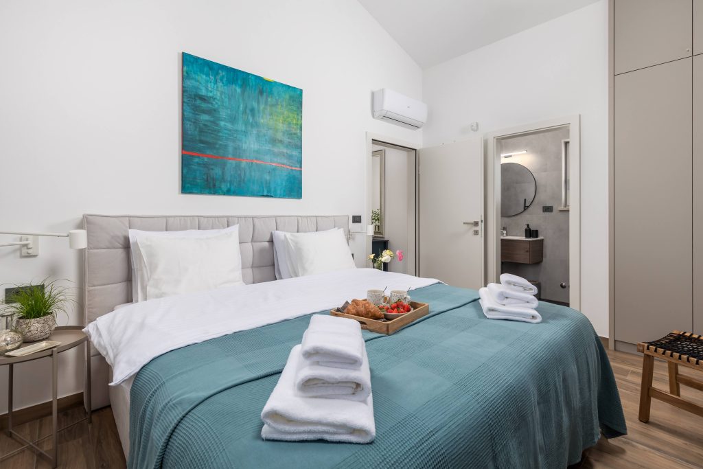 Bedroom breakfast tray with croissants and teal throw