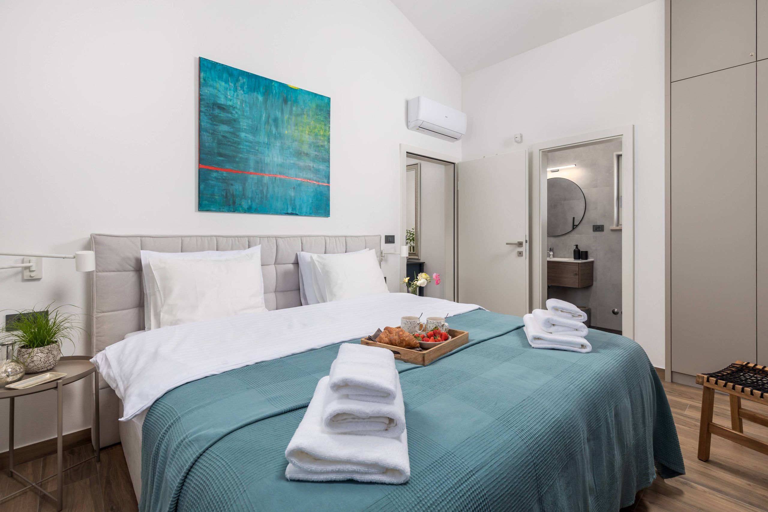 Bedroom breakfast tray with croissants and teal throw