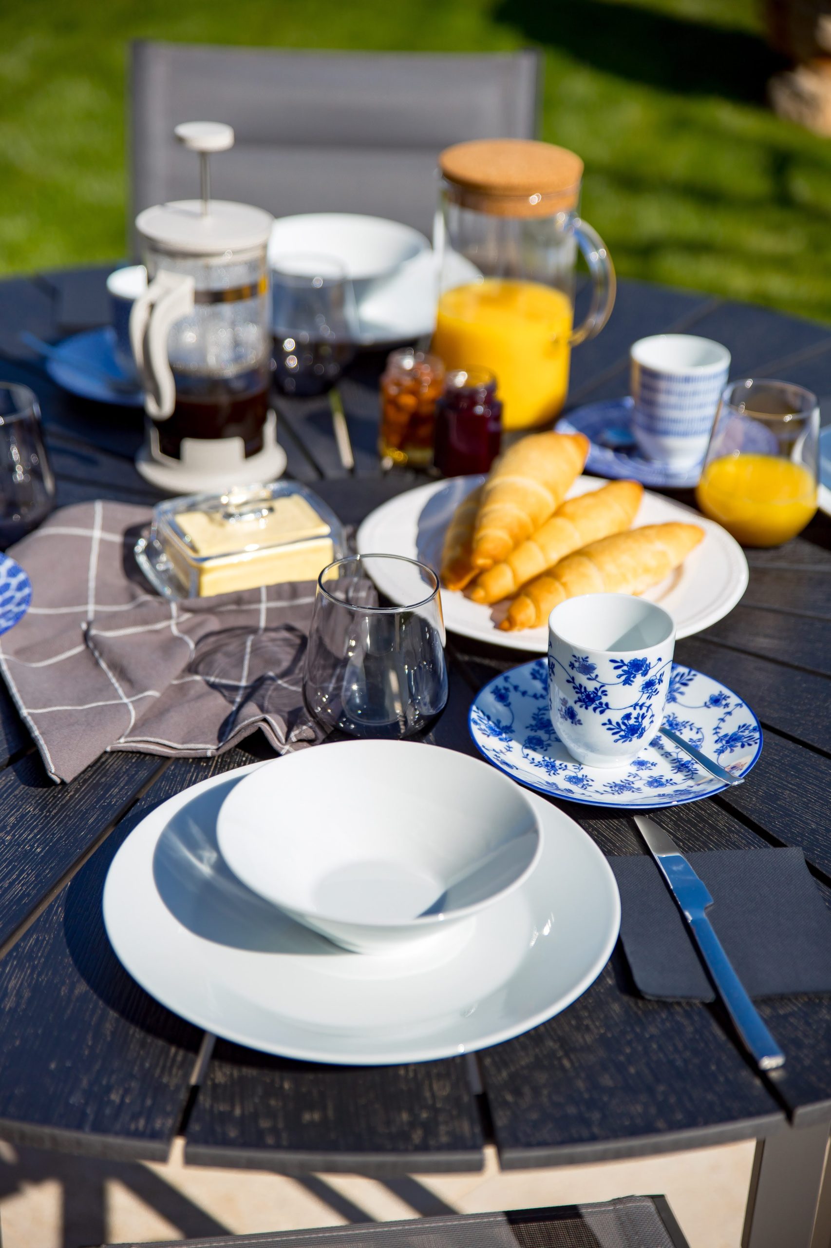 Breakfast table close-up with croissants, coffee and orange juice
