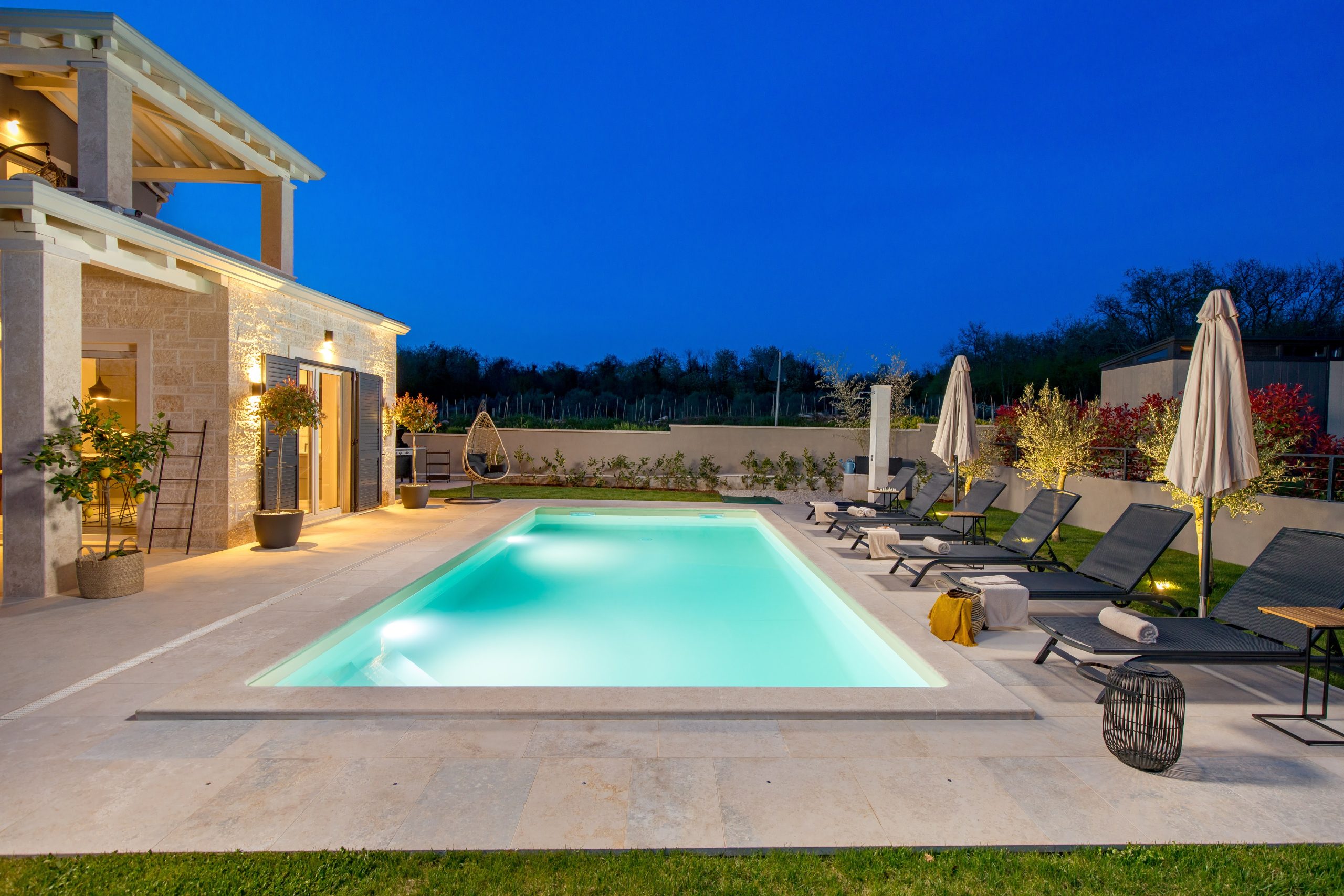 Pool and hanging chair at dusk