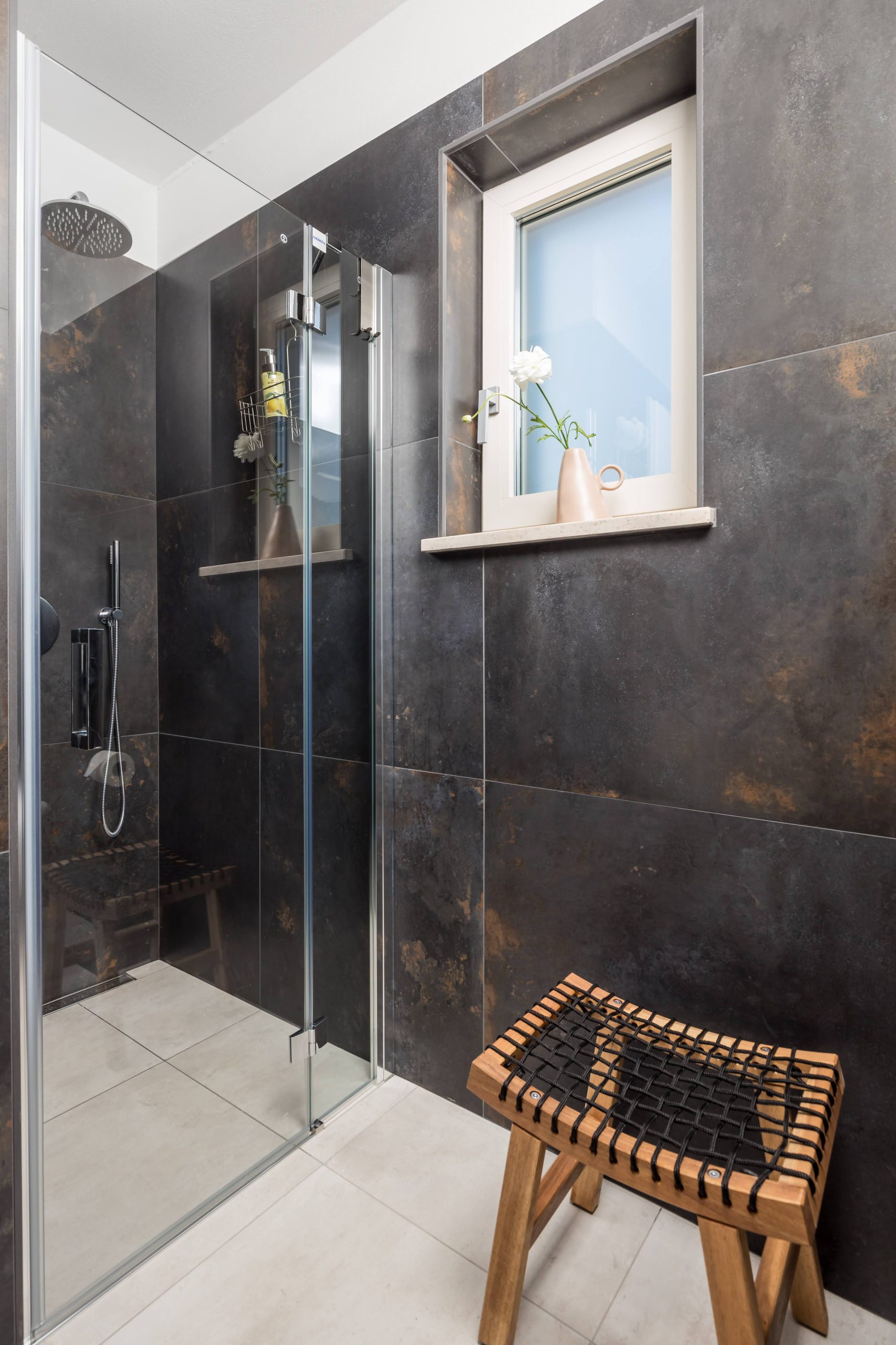 Ensuite bathroom with dark tile walk-in shower