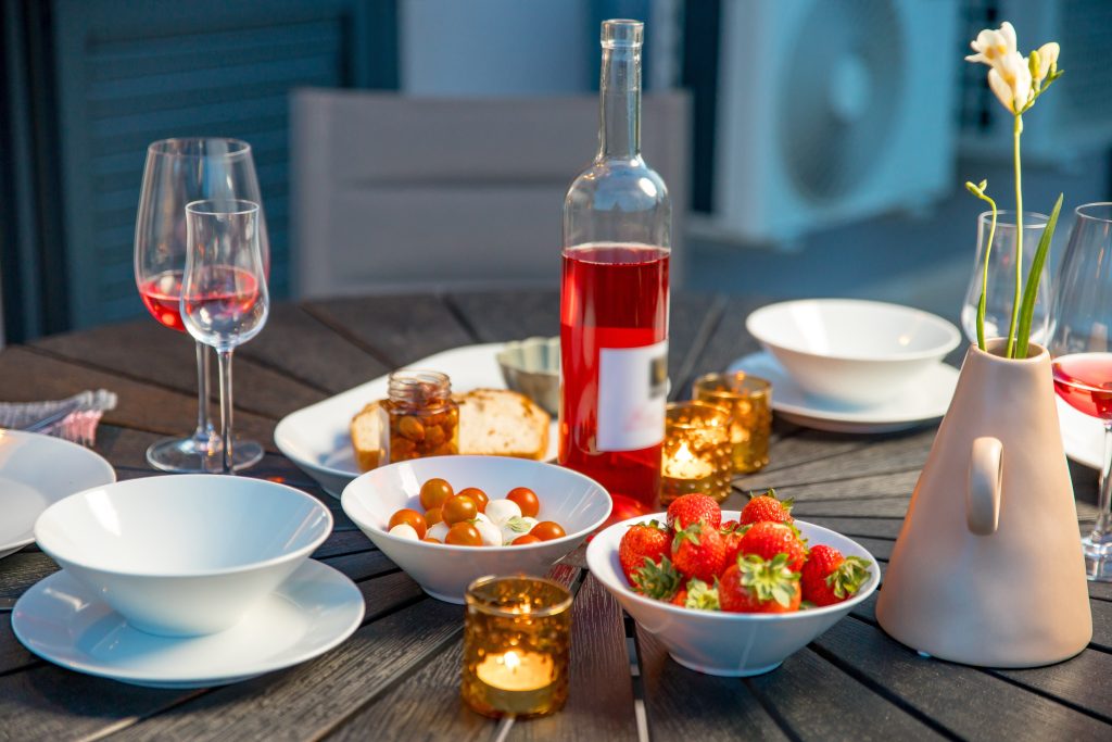 Evening aperitif with wine and fresh strawberries on the terrace