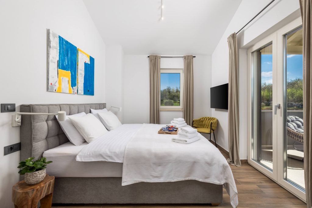 Master bedroom with king-size bed and flat-screen TV