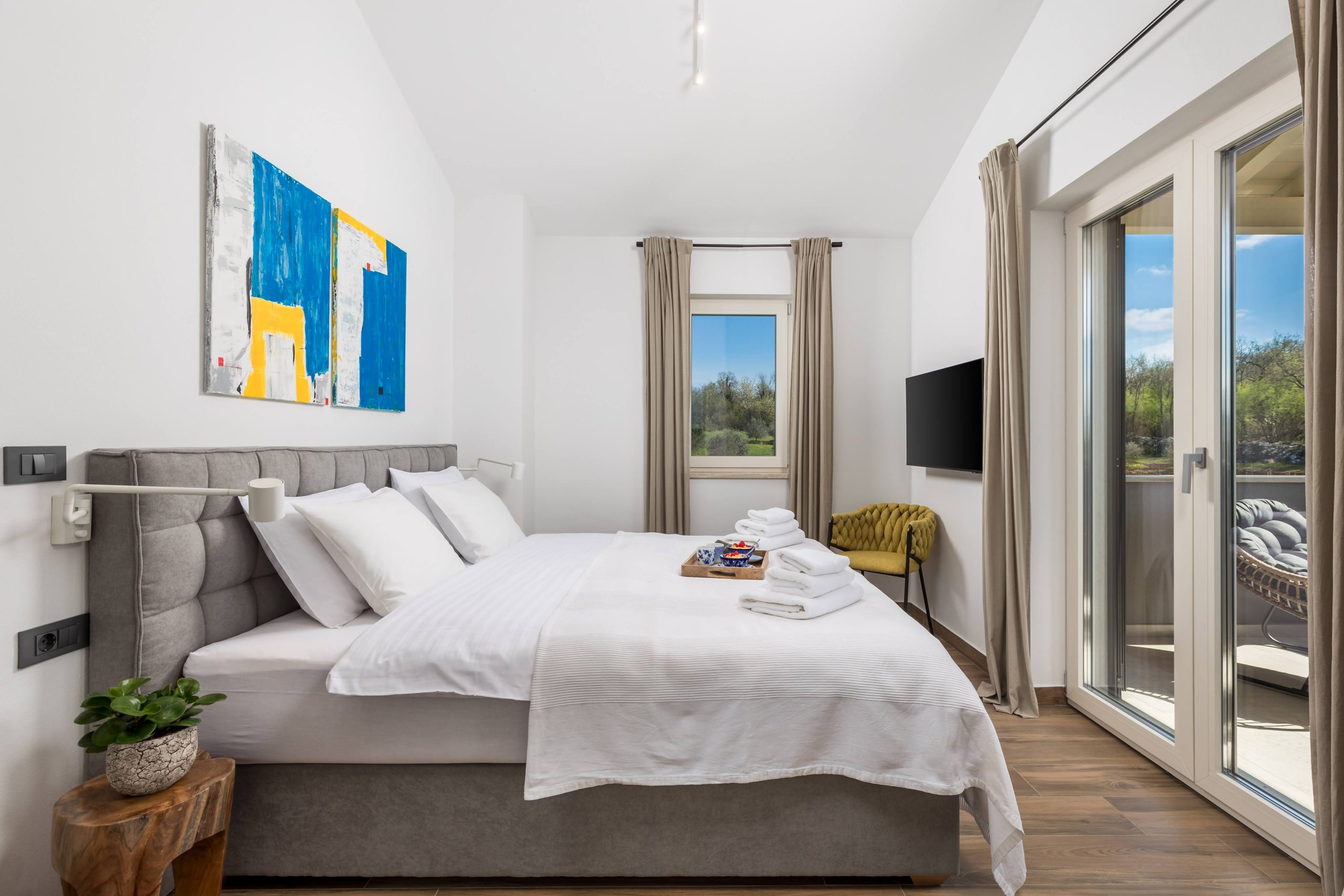 Master bedroom with king-size bed and flat-screen TV