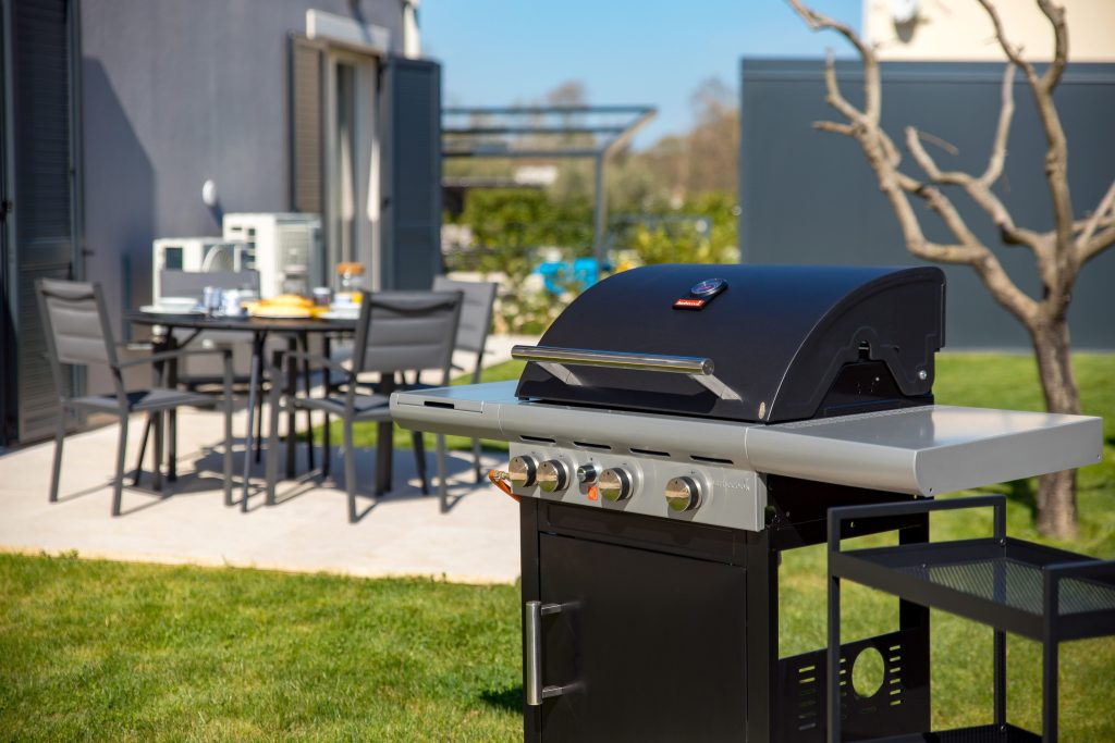 Outdoor gas barbecue grill on the garden terrace