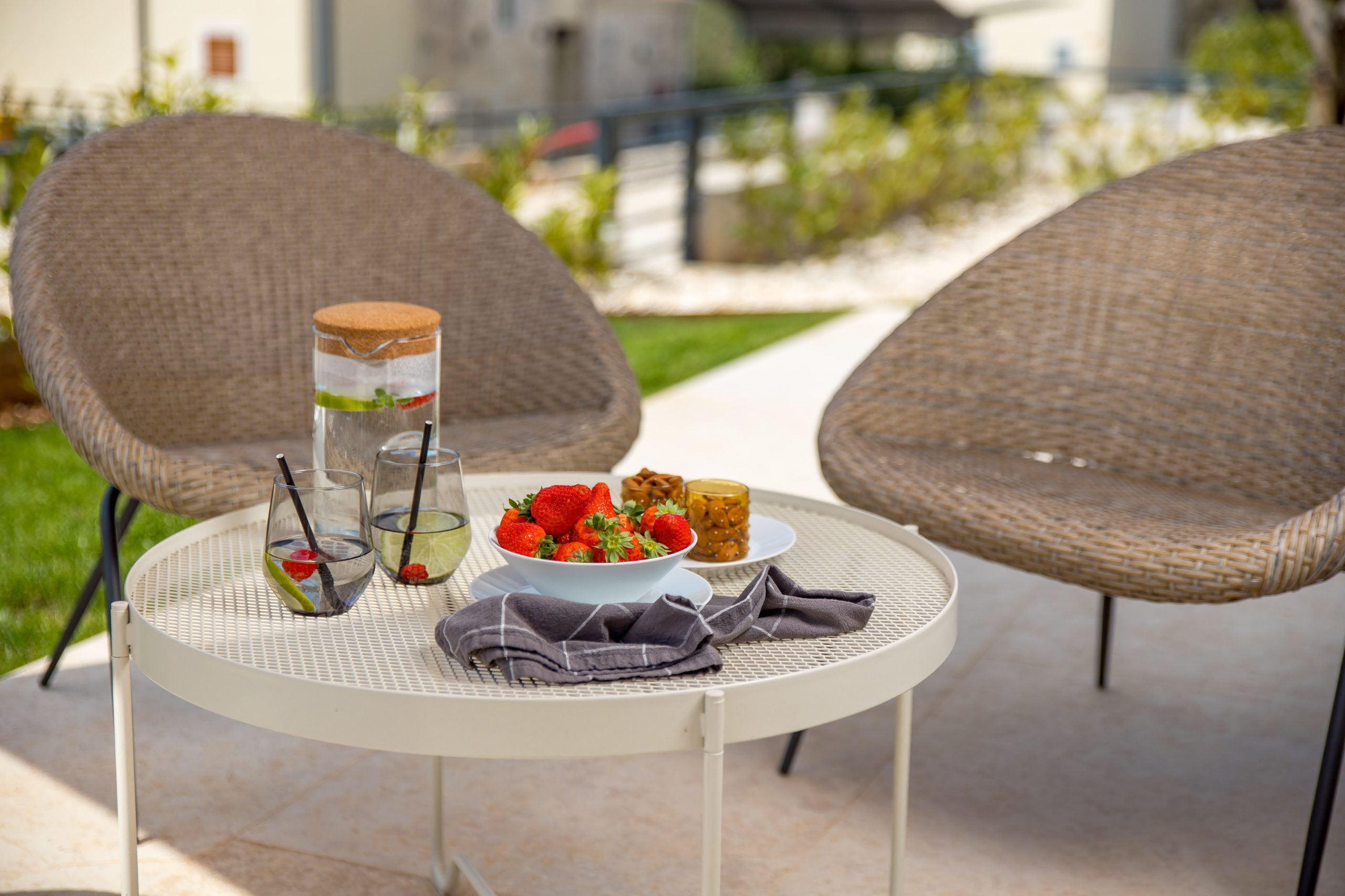 Outdoor lounge chairs with refreshments in the garden