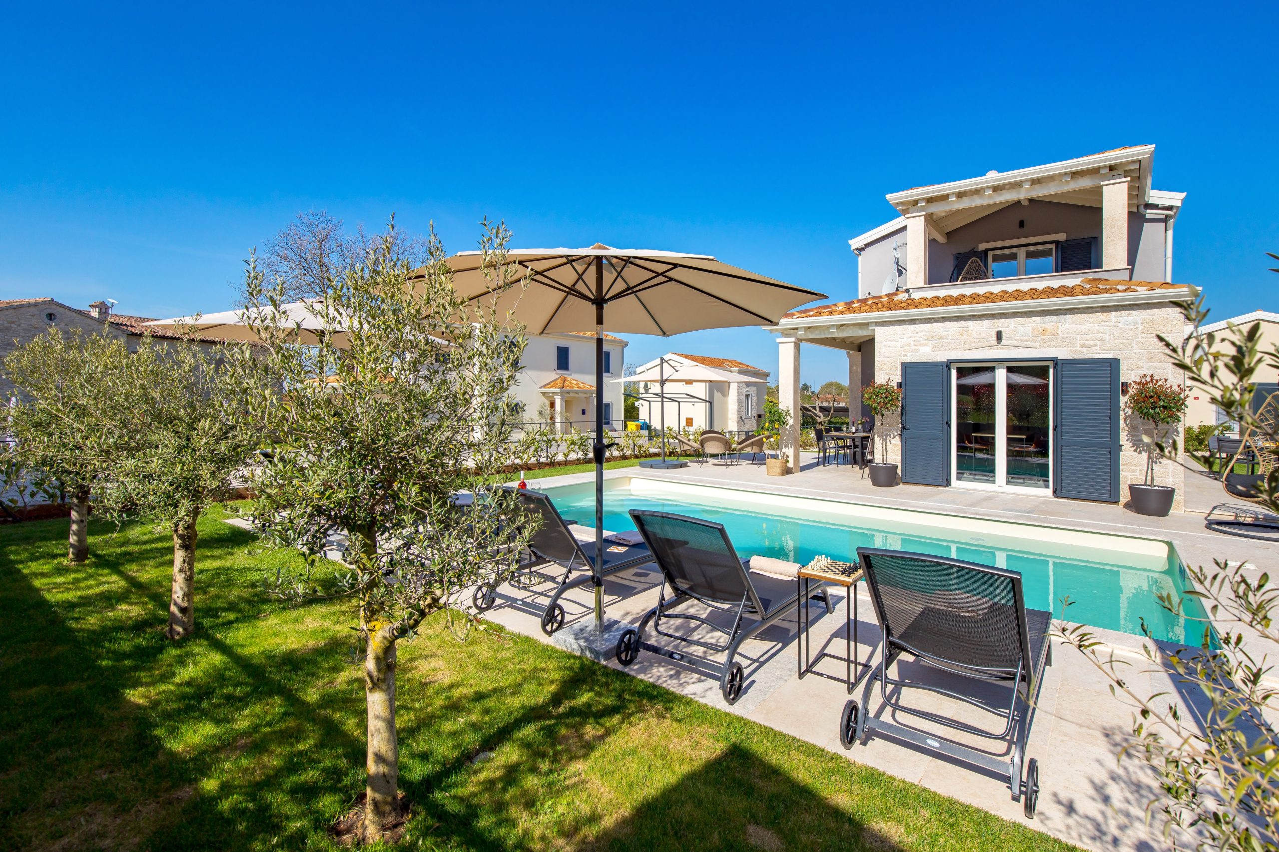 Panoramic garden view of the pool and lawn