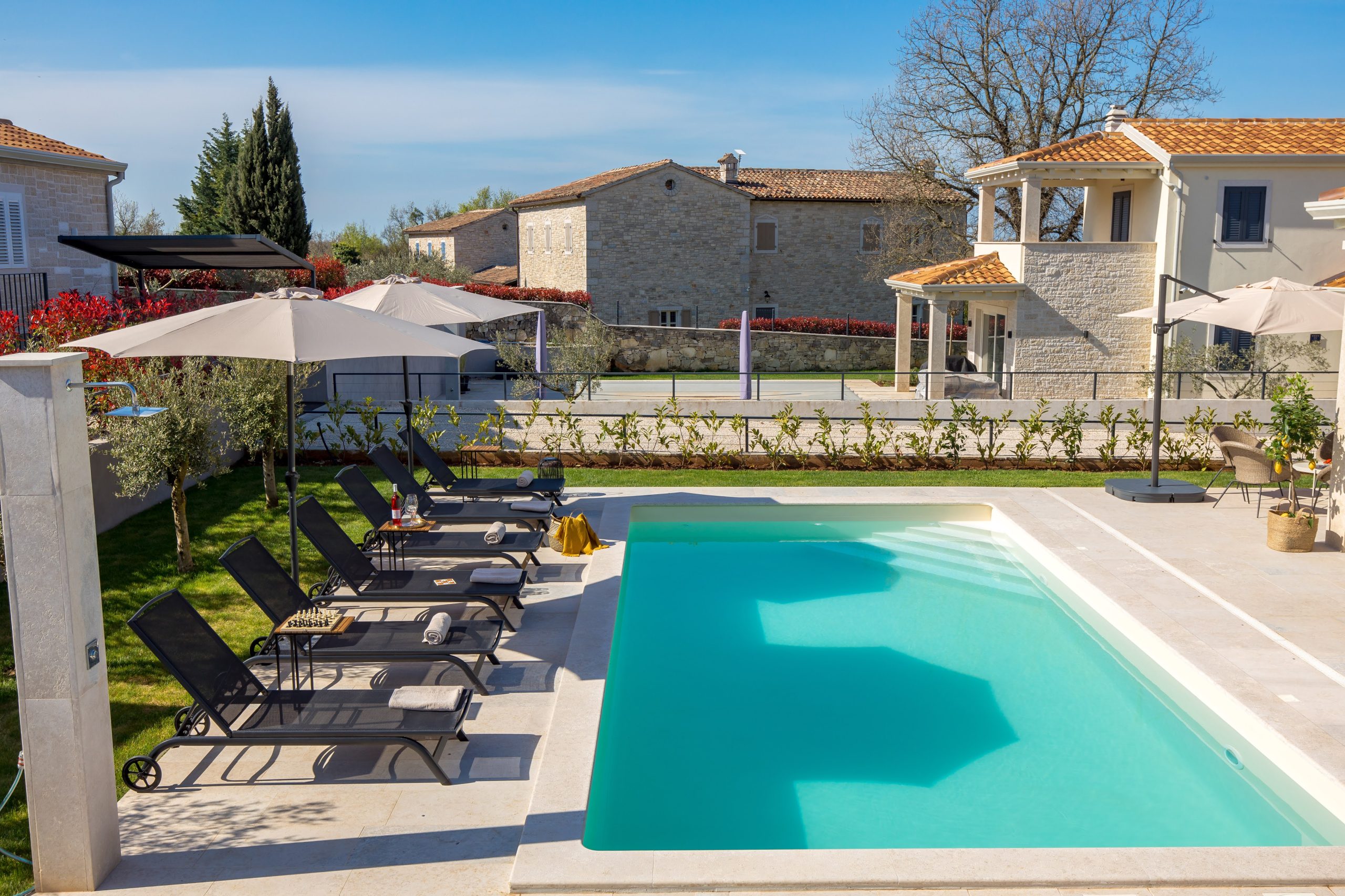 Private pool with view toward the neighboring stone house