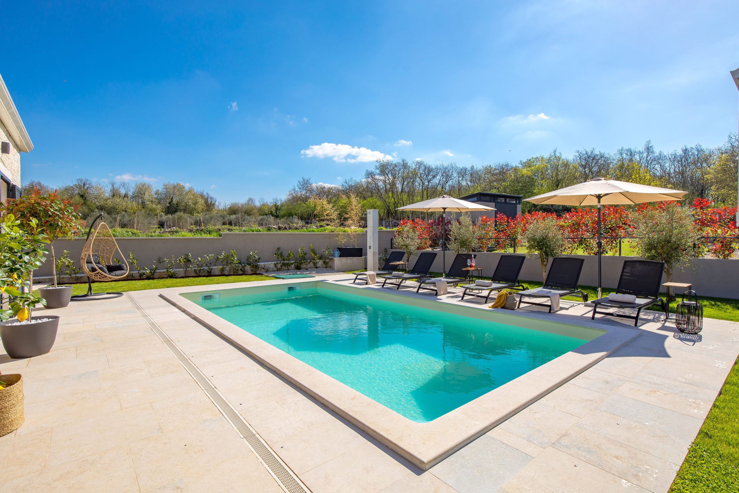 Pool with parasols and panoramic garden view