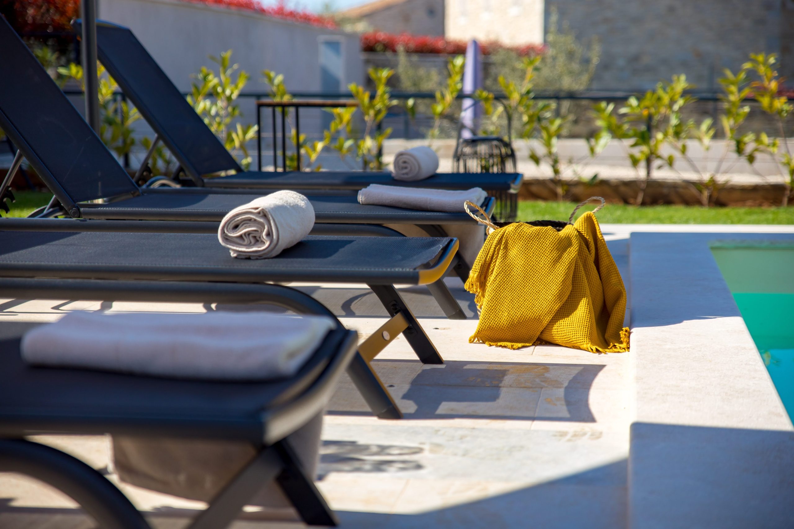 Fresh towels and beach bag ready by the pool