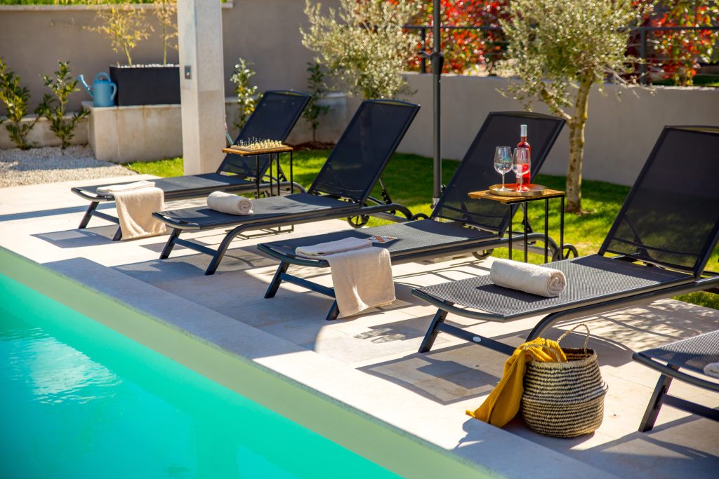 Poolside relaxation corner with towels and sun loungers