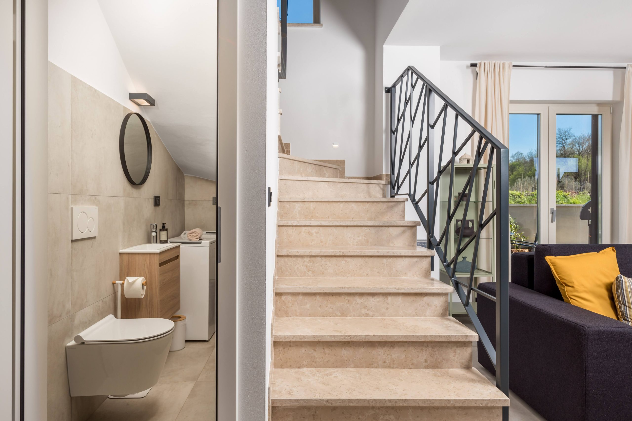 Staircase with view into the laundry bathroom